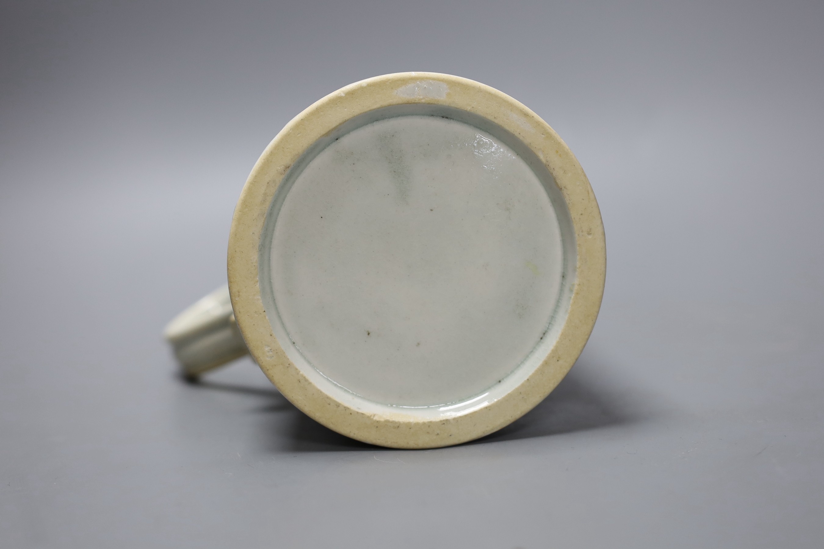 A Liverpool mug, decorated in blue underglaze with flowers and a cell border, 16cm